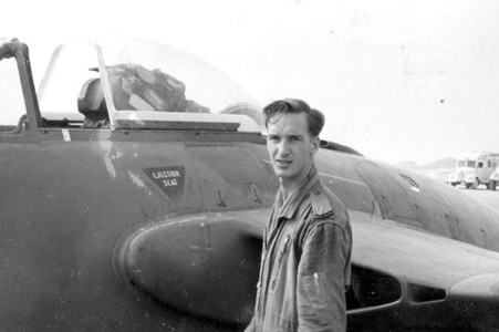 RAF Flight Lt Owen Watkinson standing in front of his De Havilland Venom.